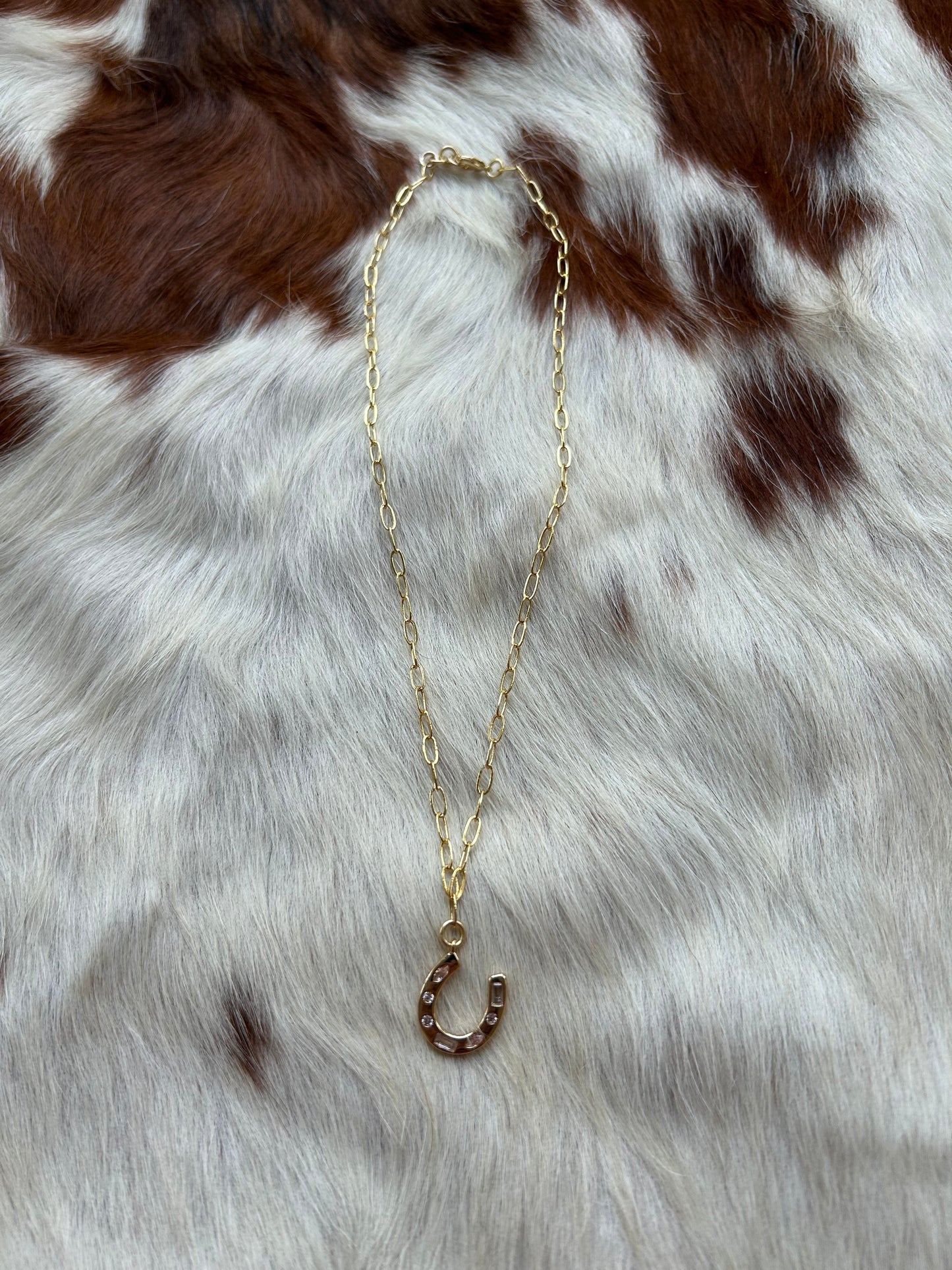 Gold horseshoe charm
