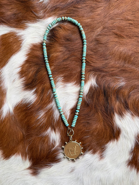 Faux turquoise and gold horse coin