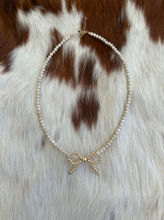 Cream and gold pearl bow