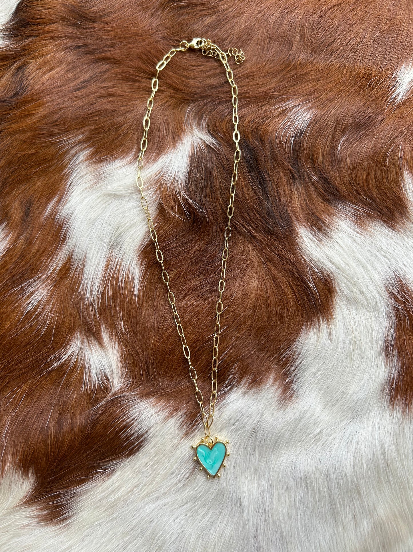 Gold paperclip and turquoise heart